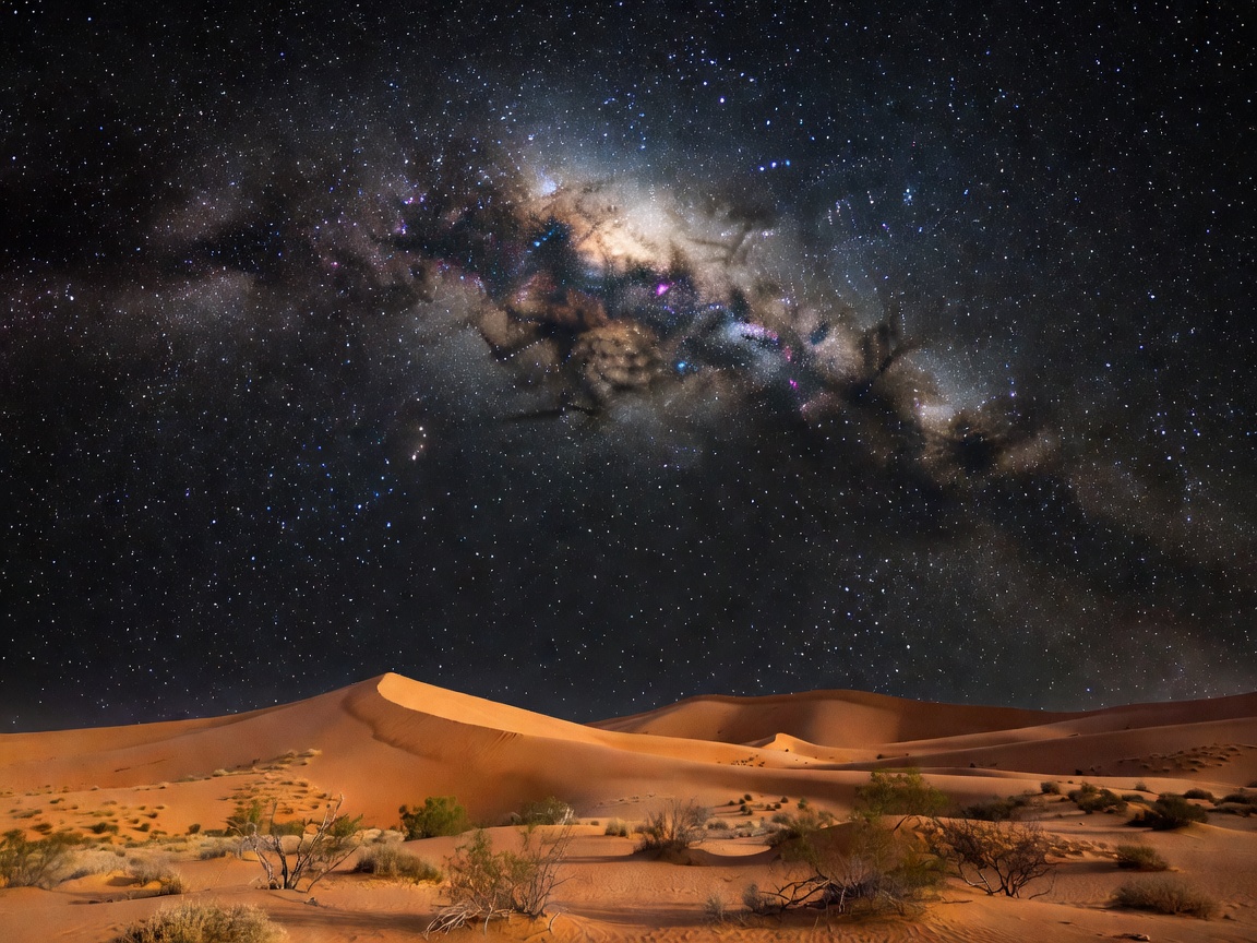 Breathtaking view of the Milky Way galaxy over rolling desert sand dunes under night sky